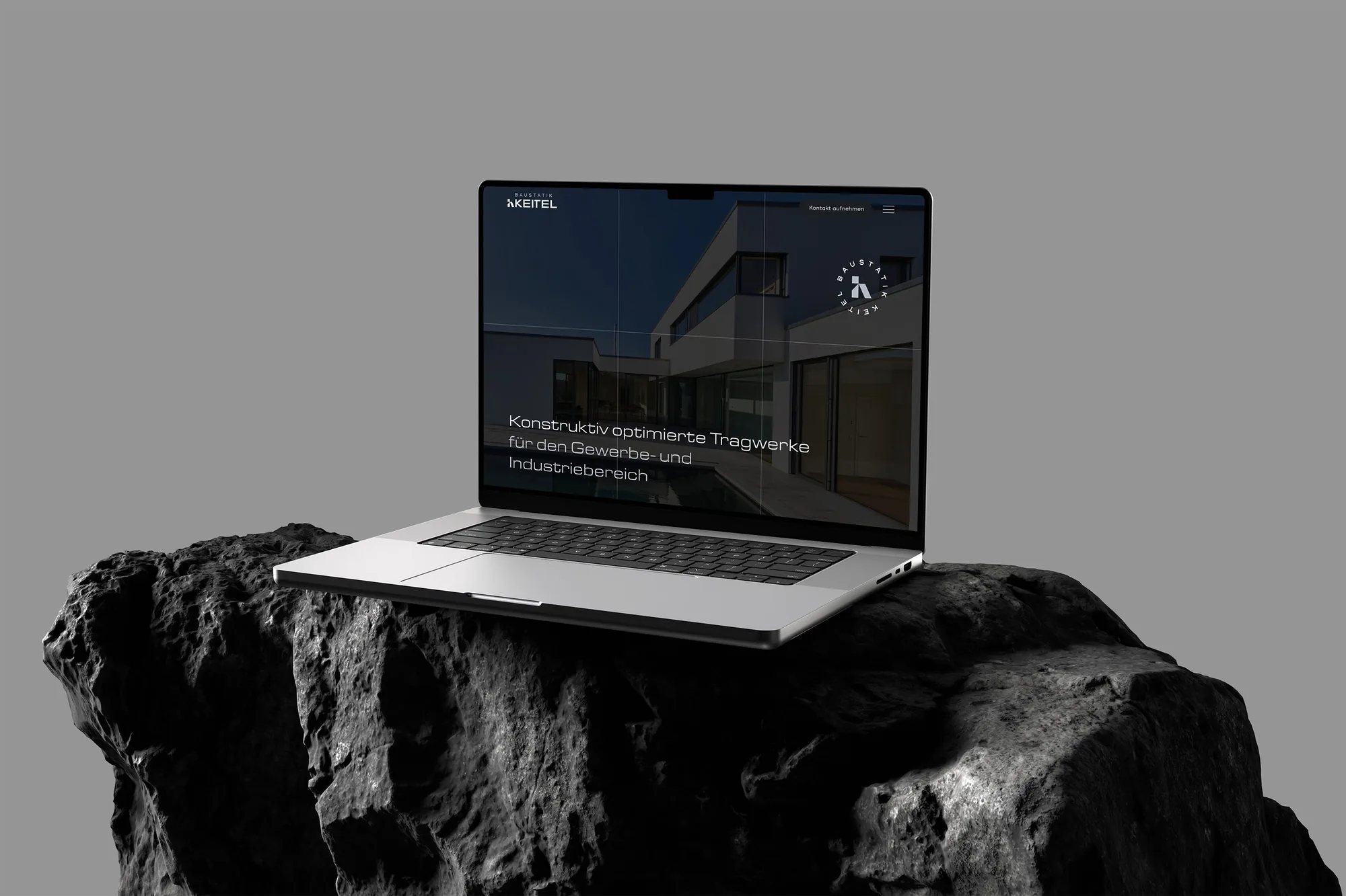 Laptop mit der neuen Website von Baustatik Keitel auf einem Felsen