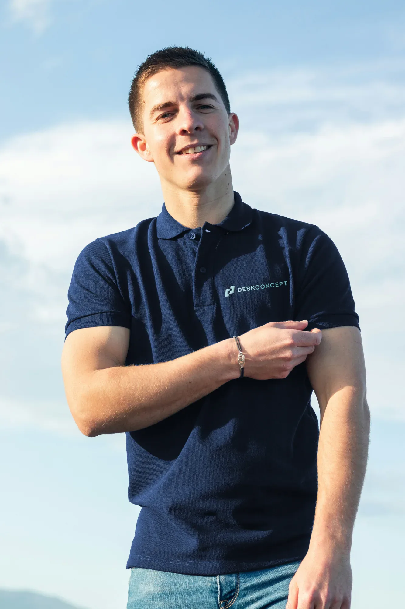 Mitarbeiter im dunkelblauen Polo mit dem Logo von Desk Concept